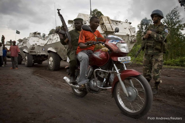 Mężczyzna podwozi kongijskiego żołnierza na linię frontu.